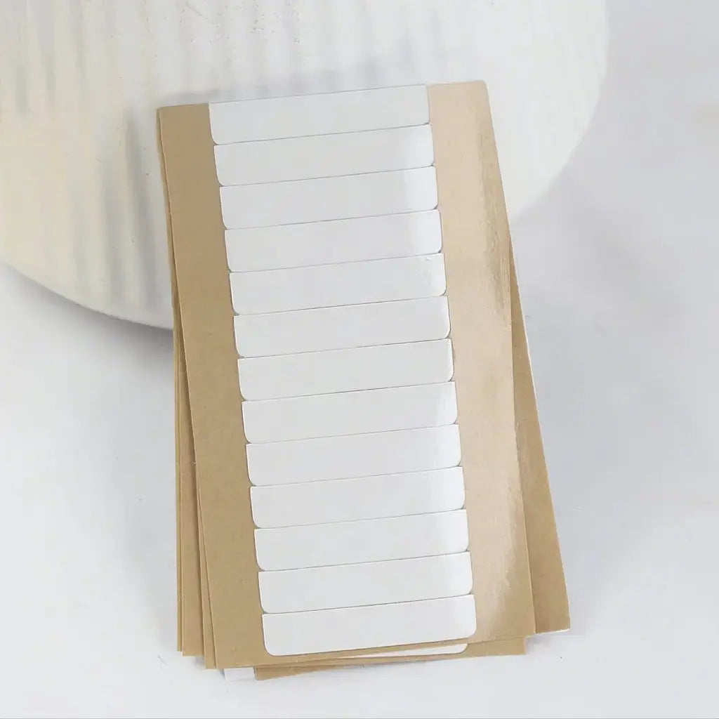 Replacement tape refills: Stacked sheets showing the protective backing and tape rows