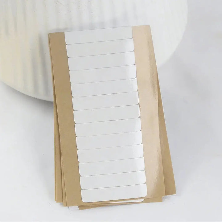Replacement tape refills: Stacked sheets showing the protective backing and tape rows