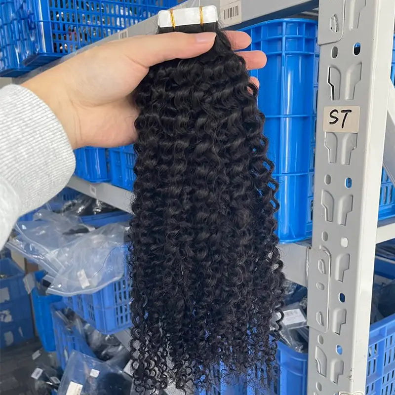 Kinky Curly tape-in extensions: Curly extensions held to show their texture