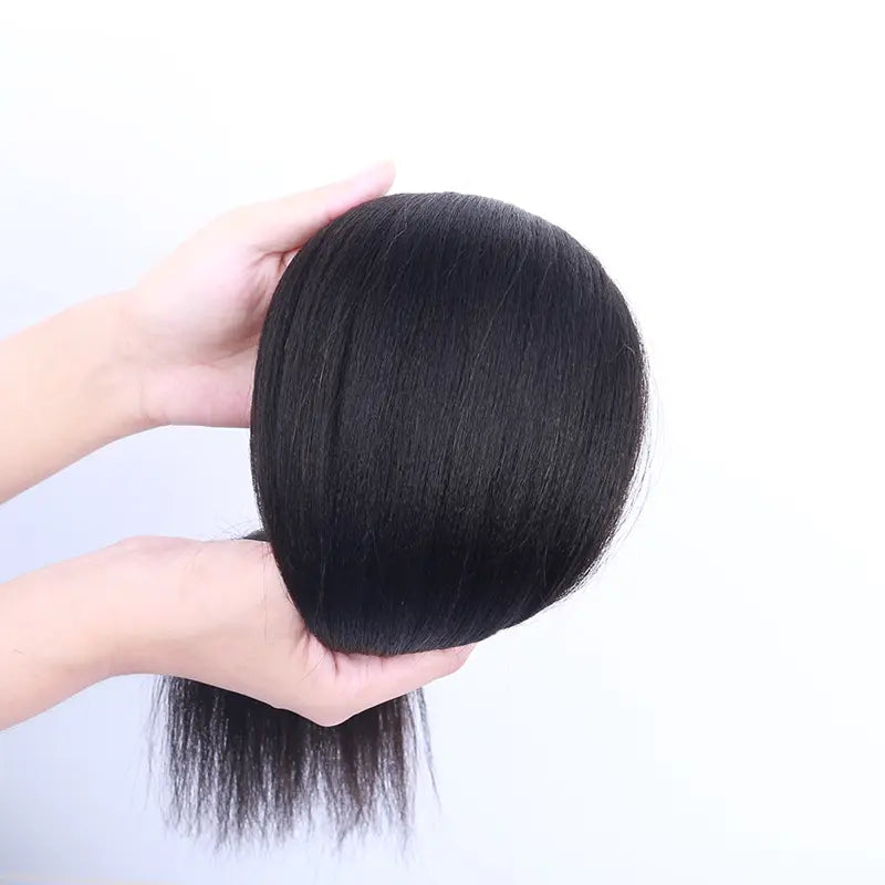 Light Yaki Straight tape-in extensions: Hair folded over a hand to show its texture