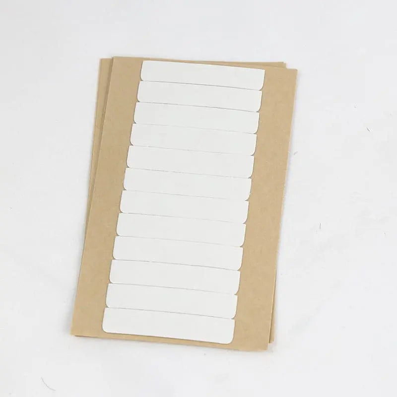 Replacement tape refills: One sheet showing rows of pre-cut white tape tabs