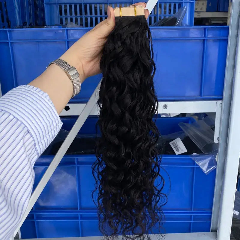 Water Wave tape-in extensions: Wavy hair held to show its full length